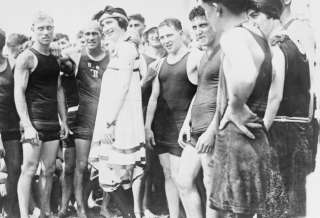 Description early 1900s photo Group of people, in swimsuits, standing 