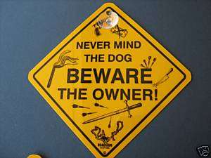YELLOW SIGN  NEVER MIND THE DOG, BEWARE THE OWNER  